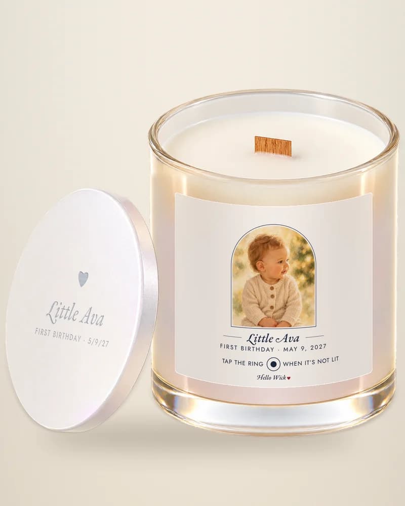 A Hello Wick candle labelled Little Ava, first birthday, with the baby in the arch